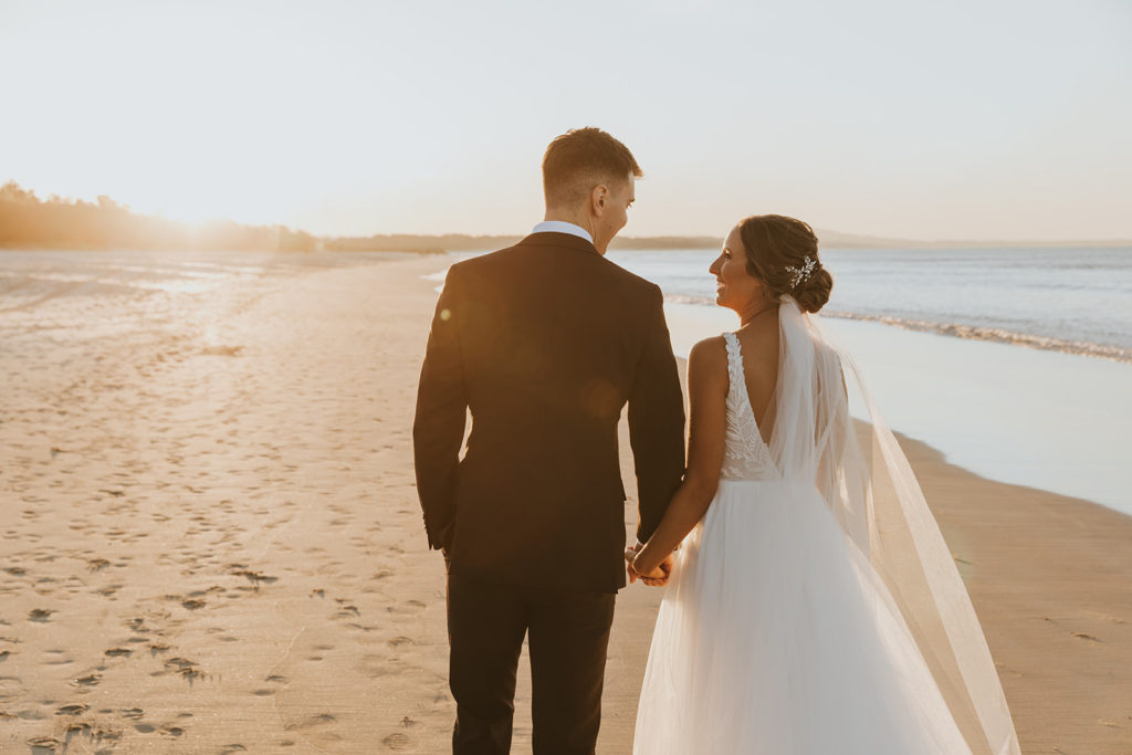 wedding couple walking on Noosa main beach